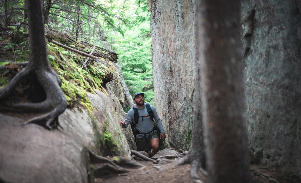 A hiker in a narrow rock crevice
