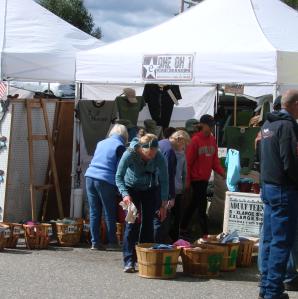 Vendor tents up on a row with people walking amongst them shopping