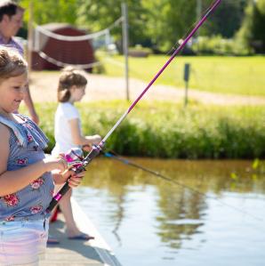 Two girls fishing from a dock