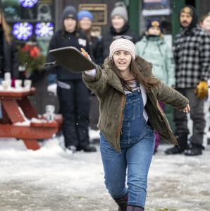 A woman tossing a frying pan in the frying pan toss