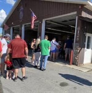 People in line at the fire department to get their chicken bbq dinner