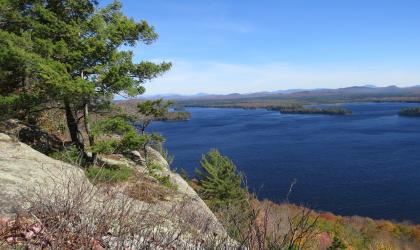 A summer view of Lake Lila from a rocky outcrop with pines.