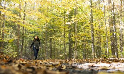 A woman walks on the trail at the AIC.
