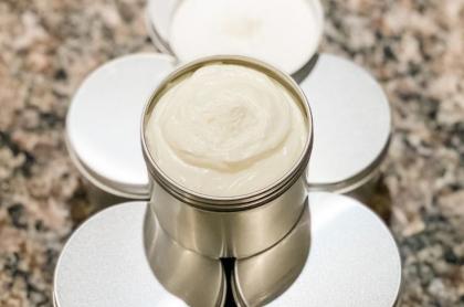 A photo of a small container with home-made lotion in it