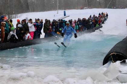 a skiier skimming across the pool of water