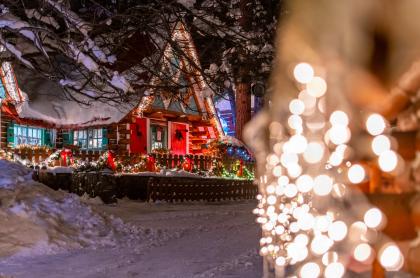 A photo of a home decorated with lights for the holidays