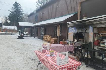 Exterior photo of Axes & Irons building with the pizza truck set up out front