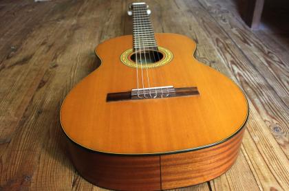a guitar laying on a hardwood floor