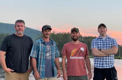 The four men who make up the band Altered Tones standing next to each other for a photo