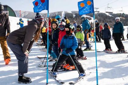 Kids lined up at the starting point of a kids downhill skiing race
