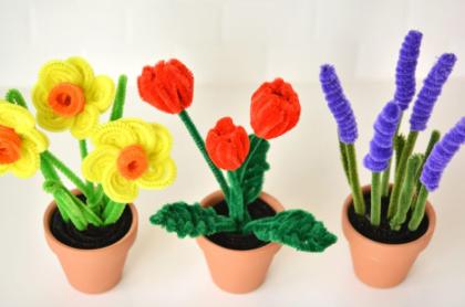 Three pots with different flowers made out of pipe cleaners
