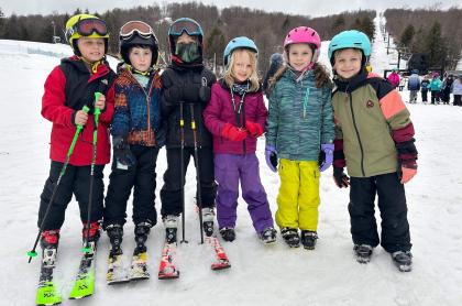 a-group-of-kid-skiiers-together-for-a-photo