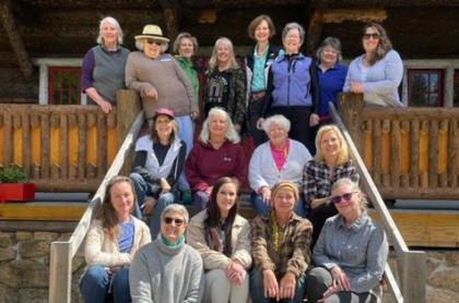 Several women on the porch of the Great Camp Sagamore for a group photo