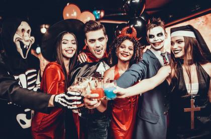 Several adults dressed up for Halloween toasting with special drinks