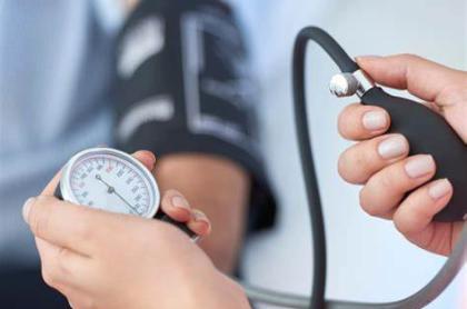 a nurse taking the blood pressure of a patient