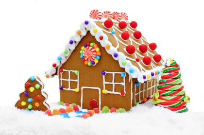 A gingerbread house decorated with white frosting and candies