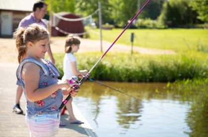 Two girls fishing from a dock