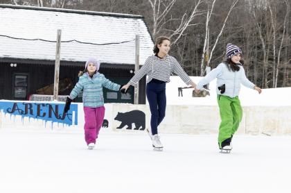 three girls ice skating