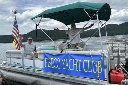 a pontoon boat with two men on board