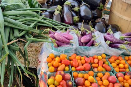 Photo of a variety of vegetables for sale at a farmers market.