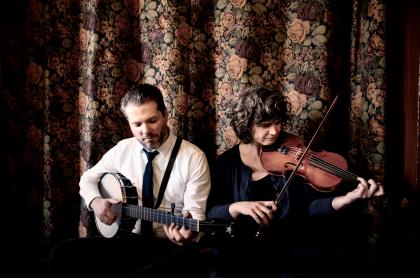 photo of the two musicians holding stringed instruments