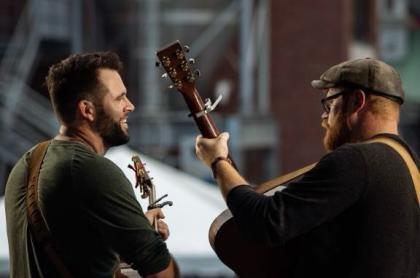 A photo of Seth and Nash performing on stage
