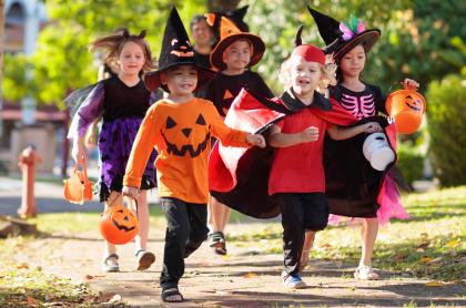A group of kids dressed up trick or treating