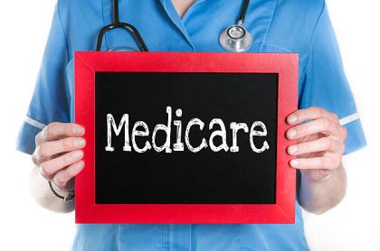 medical-person-holding-up-a-sign-that-reads-medicare