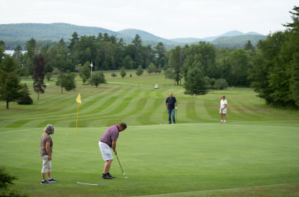 People golfing