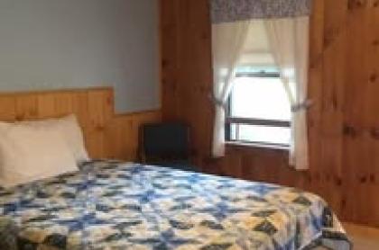 The blue and white quilt on a bed in one of the rooms at The Blueberry Hill Motel.