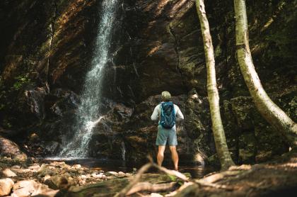 A hiker at a waterfall