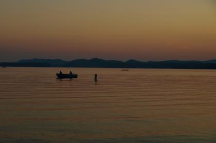 A lake during a hazy sunset.