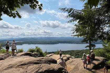 People at an overlook on a cliff with a view of the water