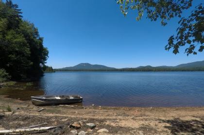 A sandy beach with mountains across the water