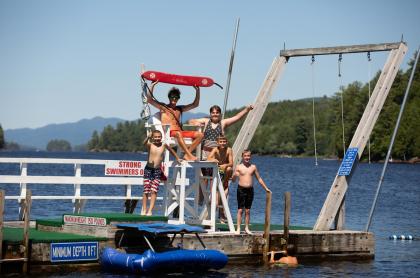 Some kids with a lifeguard on a floating dock in Long Lake.