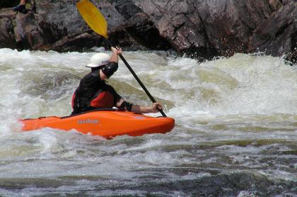 A whitewater kayaker navigating rapids