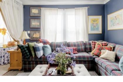The formal sitting area with large window and plaid sectional couch