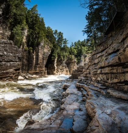 A view of the water rushing past with the towering walls of the gorge surrounding you