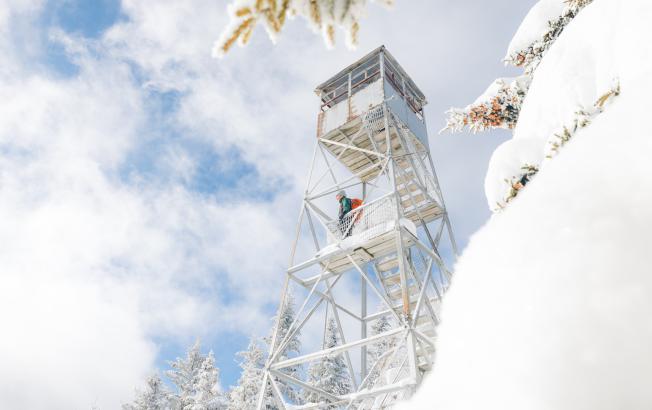 A winter hiker in a fire tower