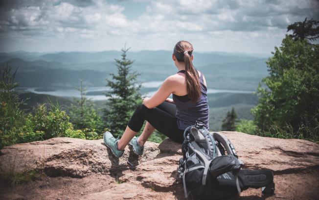 A hiker on the summit of Snowy Mountain