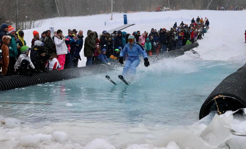 a skiier skimming across the pool of water