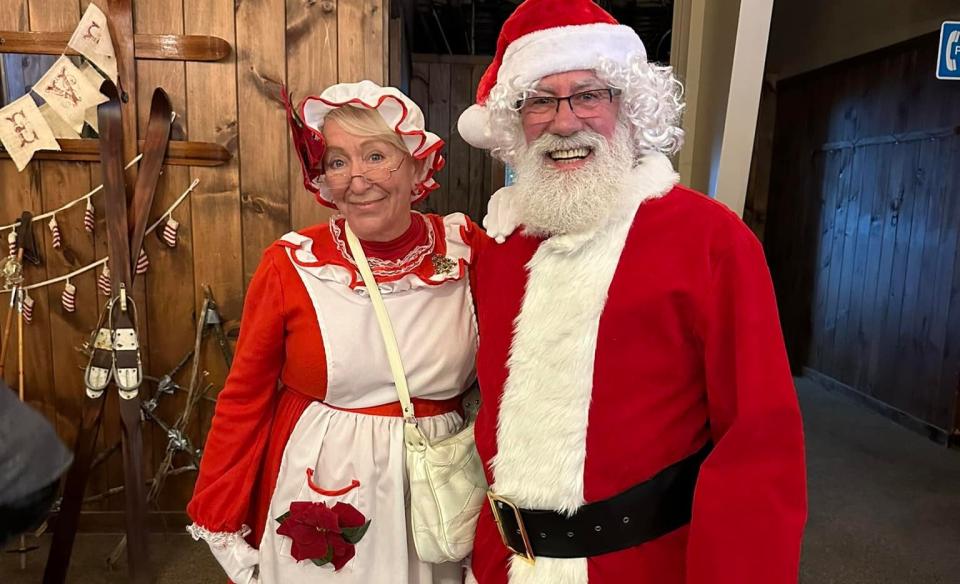 A couple dressed up as Mr & Mrs Clause