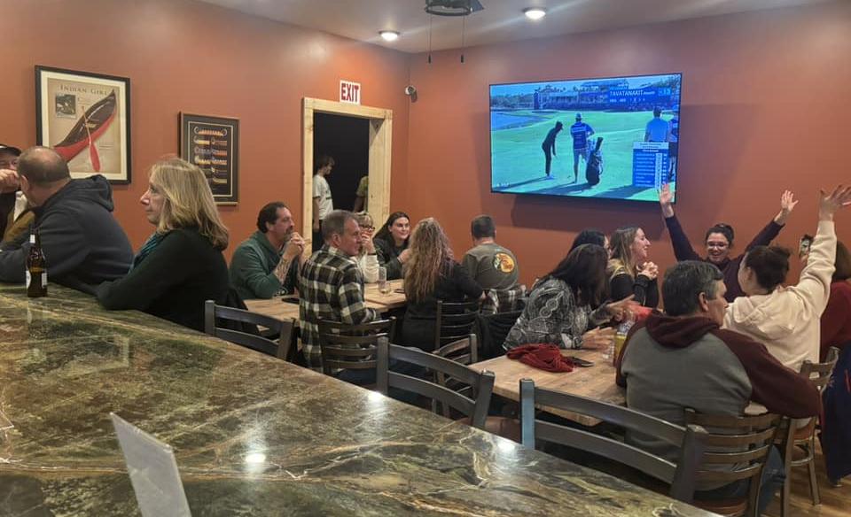 People sitting inside at tables