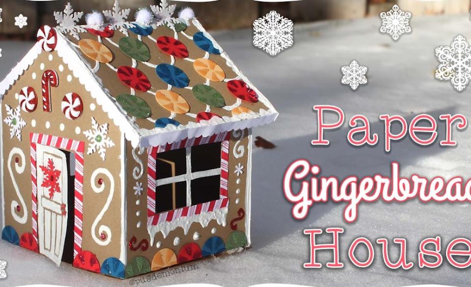 A very decorative gingerbread house made out of paper and decorated with paper candies