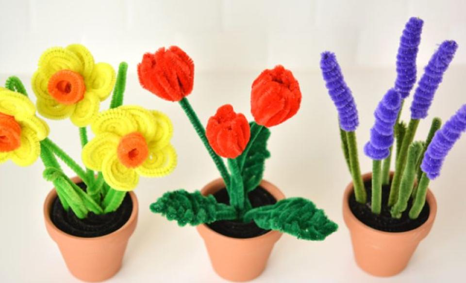 Three pots with different flowers made out of pipe cleaners