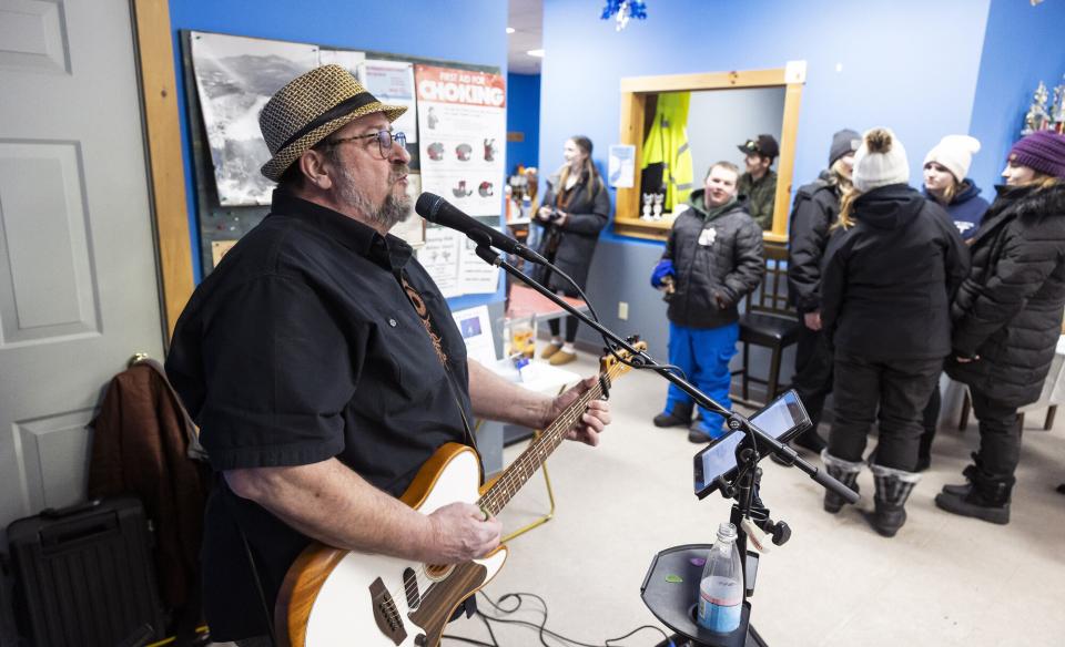 a man performing live music at the Indian Lake Welcome center