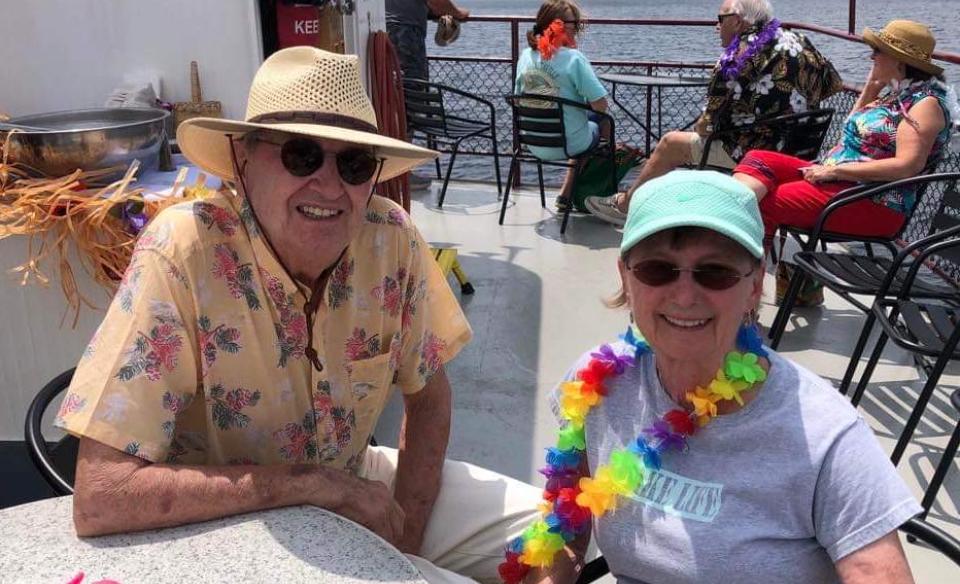 A couple dressed in tropical attires and colors