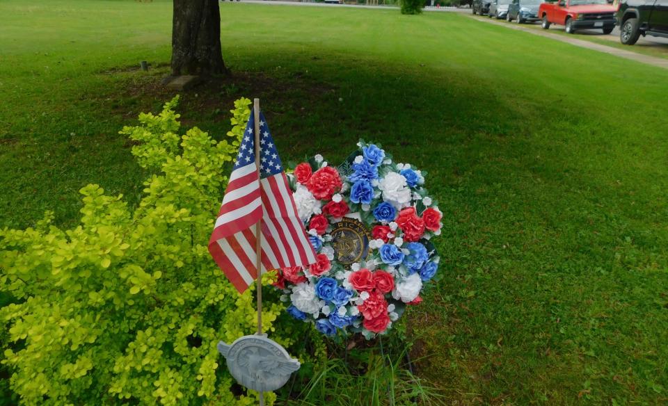 A memorial wreath and American flag