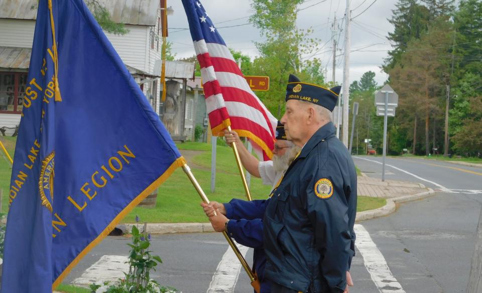 Men from the American Legion carrying flags