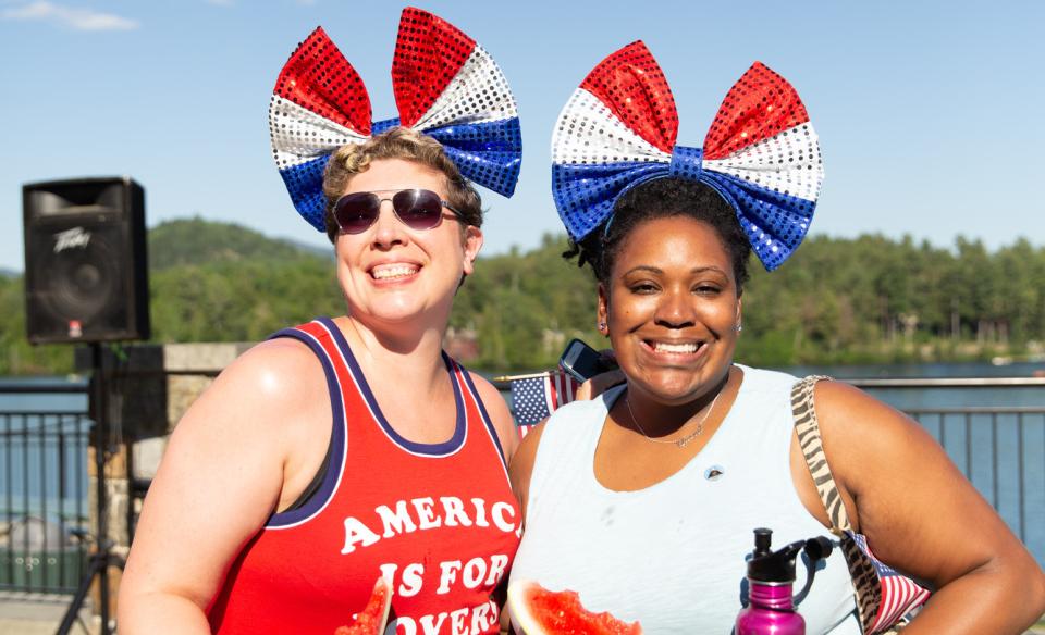 two ladies dressed in partritoic colors with big red